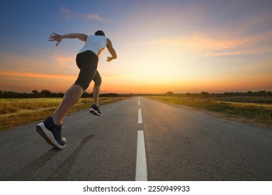 A man running on country road with sun dawn sky background.

 - Powered by Shutterstock