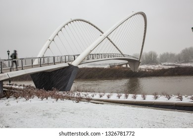 A Man Running On The  Peter Courtney Minto Island Bridge During A Snow Storm In Salem, Oregon