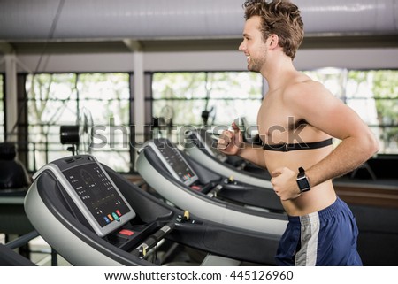 Man running on thread mill at gym