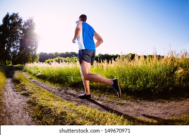 Man Running Outdoors During Sunset