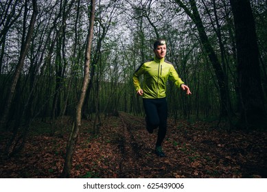 Man Running Outside In Nature At Rainy Night With Headlamp