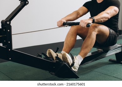 Man running rowing excercise in the gym