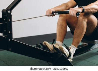 Man Running Rowing Excercise In The Gym