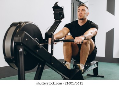 Man Running Rowing Excercise In The Gym