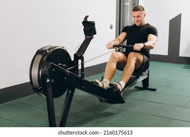 Man Running Rowing Excercise In The Gym