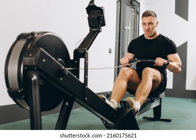 Man Running Rowing Excercise In The Gym