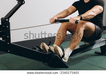 Man running rowing excercise in the gym