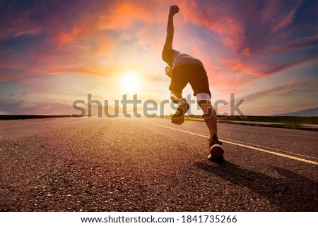 man running and sprinting on road with sunset background