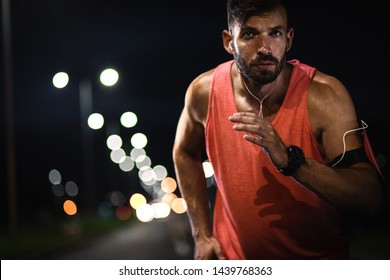 Man Running Through The City At Night.