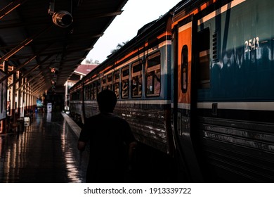 A Man Running At The Train Station In The Evening.