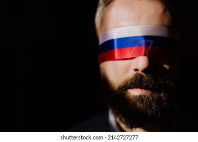 Man With Russian Flag Blindfold On Black Background, Russian Propaganda Closed People's Eyes Concept.