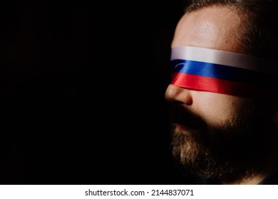 Man With Russian Flag Blindfold On Black Background, Russian Propaganda Closed People's Eyes Concept.