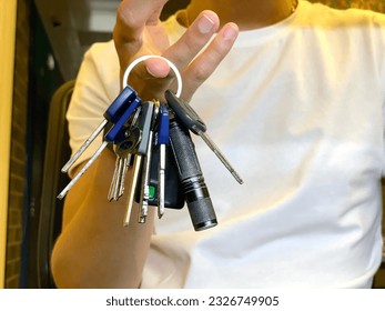 man 's hand holding keys in the hands of a woman. a  woman is holding keys in her hand. selective focus. high quality photo