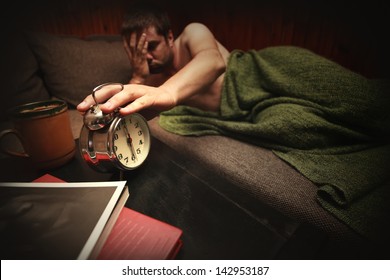 Man With Sad Expression Touch Clock In Early Morning