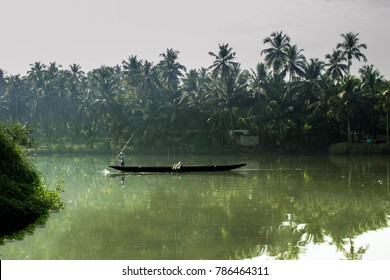 Man Sailing Boat In Kerala Backwaters
