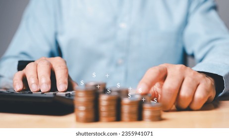 A man sat at his desk, calculating the potential returns on his investment in a new business. He dreamed of growing his wealth and building a better future for himself and his family. - Shutterstock ID 2355941071