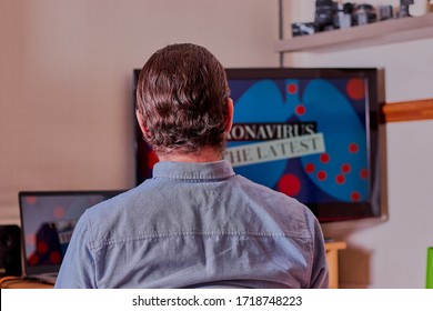 Man Sat Watching News On Multiple Screens,the Image Was Shot Close Up And Straight On.