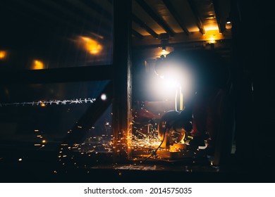 A man is sawing metal pipes on a plunge-cut miter saw. Sparks is flying from under the disc. The working process. DIY construction. Hobby. Safety precautions for using power tools. Protection means. - Powered by Shutterstock