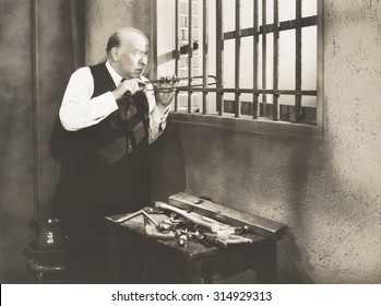 Man sawing through bars