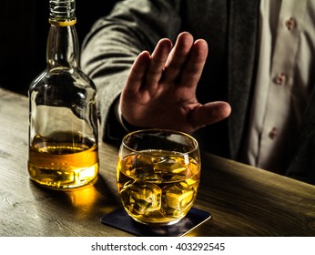 Man saying no more to alcohol with his body language