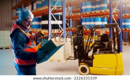 Man with scanner in warehouse. Customs clearance. Guy works as customs inspector. Man uses barcode scanner. Storage supervisor. Gray-haired customs inspector registers postal items.
