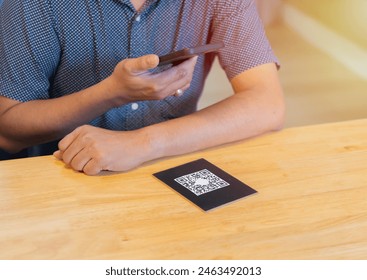 Man scanning the barcode qr code in restaurant or cafe. Qr code payment, E wallet , cashless technology concept.
