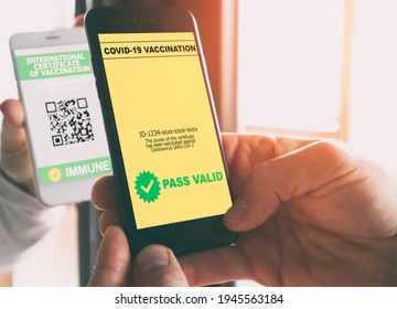 The man scanning the digital vaccination certificate of person by his phone and finds its valid - Shutterstock ID 1945563184