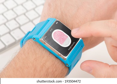Man is scanning fingerprint for mobile security with blue smart watch.
