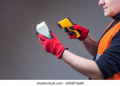 Man Scans A Barcode. Human Is Checking A Barcode On A Box. Concept - Classification In Stock By Barcode. Man Uses A Scanner To Work In A Warehouse. Concept - A Portable Scanner At A Warehouse Worker.