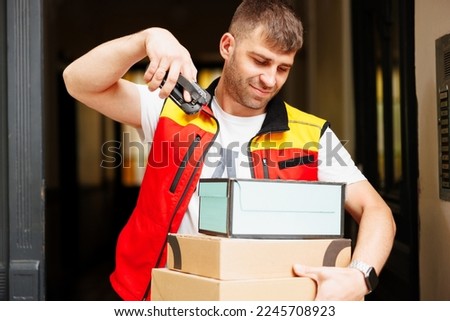 The man scans the boxes before delivering them