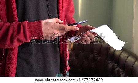 A man scans the QR code on a check from a supermarket