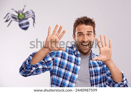 Man, scared and spider with shout in studio with arachnophobia terror or scream, wildlife or white background. Male person, hands and insect fear or animal danger on mockup space, afraid or tarantula