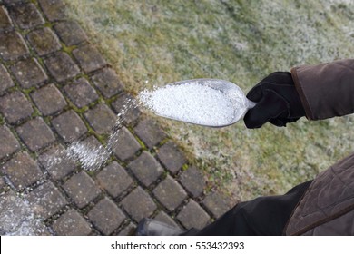 Man scattering salt in winter for de icing
