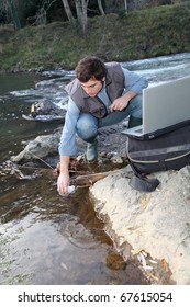 Man Scientist Testing Quality Of Water In River