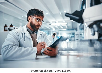 Man, scientist and writing on tablet in lab for microscope research, medical data and science information. Person, researcher and digital for study feedback, vaccine solution and biotechnology cure - Powered by Shutterstock