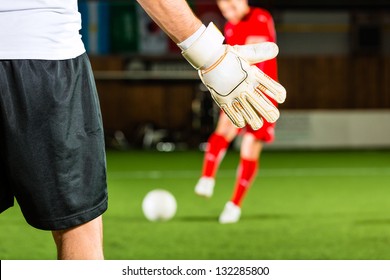 Man scoring a goal at indoor football or indoor soccer