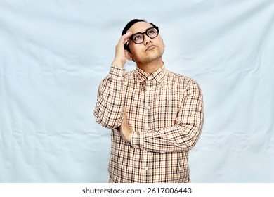 Man scratching head with a puzzled expression, as if trying to remember something.