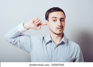 Man Scratching An Itch In His Ear