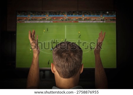 a man screams emotionally while watching TV. A fan is rooting for his favorite football team at home.