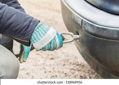 Man Screw In Tow Bar In Car