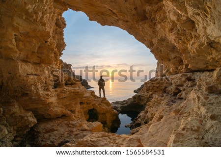 Man in sea grotto. Sea cave mainsail nature landsacpe. 