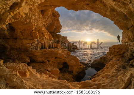 Man in sea grotto. Sea cave mainsail nature landsacpe.