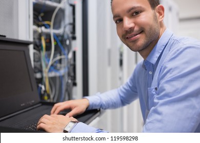 Man searching through servers in data center