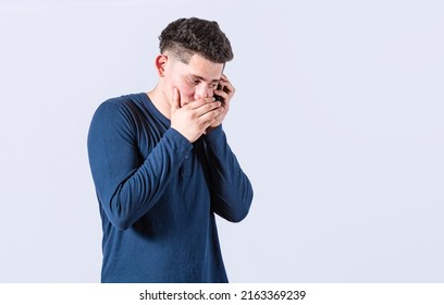 Man Secretly Talking On The Phone, On An Isolated Background. Man Talking On The Phone Covering His Mouth, Young Man Secretly Talking On The Phone, Man On A Confidential Call