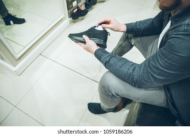 Man Seek New Sneakers In Store. Shopping Concept. Shoes Fashion Buy Shopping