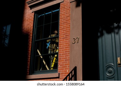 A man is seen doing construction work inside a brick building in New York City