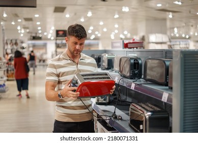 Man Selecting Toaster In Mall