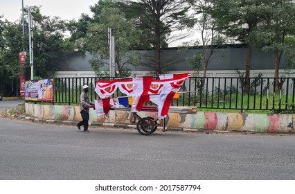 a man selling Indonesian national flag with push cart. Jakarta, 1 August 2021.