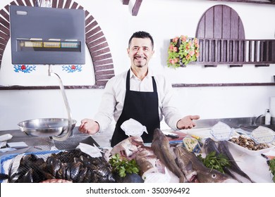 A man sells fish in a fish shop