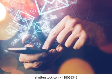 Man sending e-mail message to mailing list contacts using smartphone, close up of hands holding phone.